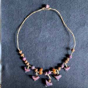 Corded necklace 5 wooden birds along with other beads. Single bead closure